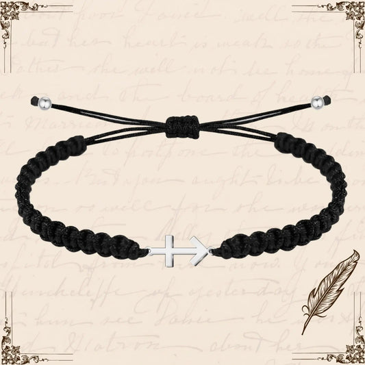 Pulsera de hilo negro trenzado con amuleto de Cruz contra el Mal en acero plateado y cierre ajustable.