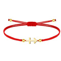 Pulsera de hilo rojo fino con amuleto de Cruz contra el Mal en acero dorado y cierre ajustable con cuentas.