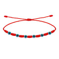 Pulsera roja de 7 nudos con siete amuletos de ojo turco de 4mm en piedra natural y cordón ajustable.