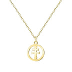Colgante tipo medalla redonda y calada con la Cruz de Caravaca en acero inoxidable dorado, con cadena a juego sobre fondo de pergamino religioso