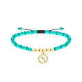 Pulsera de cuentas turquesas con charm de paraguas de Celedón dorado, tarjeta con frase rebelde en euskera "Si no nos dejan soñar, no les dejaremos dormir"