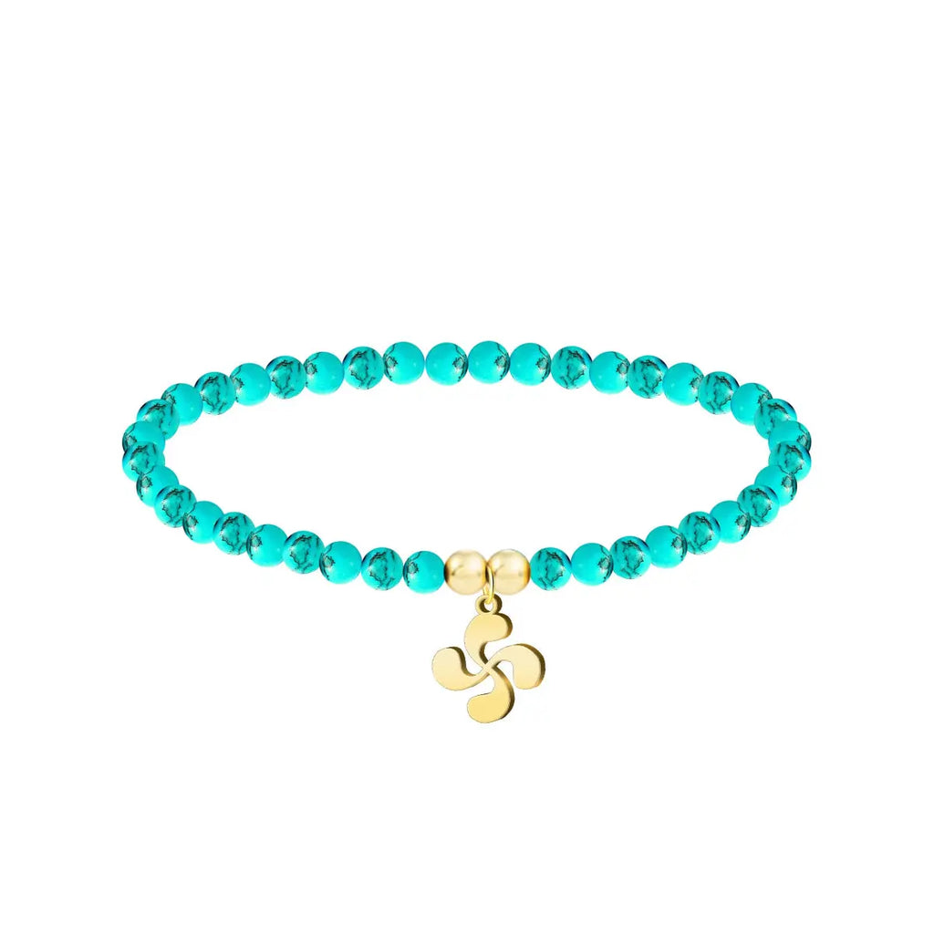 Pulsera de hilo color turquesa con entrepieza de Lauburu dorado, tarjeta con frase en euskera sobre la superación y el futuro