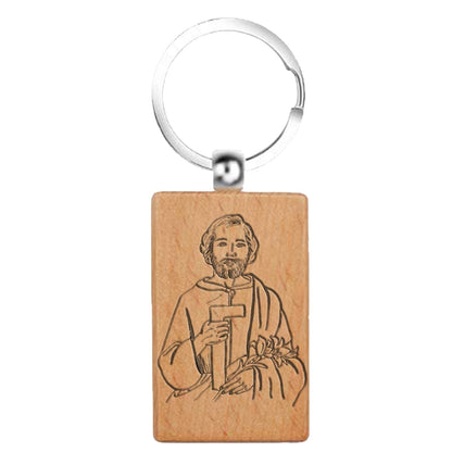 Llavero rectangular de madera natural con bordes redondeados y grabado lineal detallado de San José Obrero sosteniendo una escuadra y lirios.
