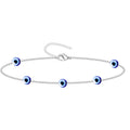 Pulsera de cadena fina plateada con múltiples amuletos de ojo turco azul en acero inoxidable.