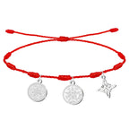 Pulsera de hilo rojo 7 nudos con tres amuletos de acero plateado: Sello de los 7 Arcángeles (izquierda), Medallón del Tetragrammatón (centro) y Nudo de Bruja (derecha).