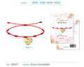 Pulsera roja de 7 nudos con colgante de corazón calado y ojo turco en acero inoxidable dorado.