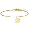 Pulsera flor de almendro en acero dorado con medalla redonda