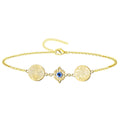 Pulsera de acero inoxidable dorado con tres amuletos de poder: la medalla de San Benito, un Nudo de Bruja con Ojo Turco azul en el centro, y el pentagrama del Tetragrammaton.