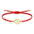 Pulsera de hilo rojo con símbolo Indalo en acero dorado