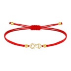 Pulsera de hilo rojo ajustable con silueta de la Virgen de Covadonga en acero dorado