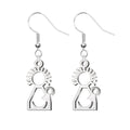 Pendientes largos de gancho con silueta calada de la Virgen del Pino en acero inoxidable plateado