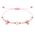 Pulsera rosa ajustable para mujer con cuentas efecto perla y detalles dorados