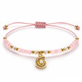 Pulsera rosa ajustable para mujer con charm de concha y cuentas doradas