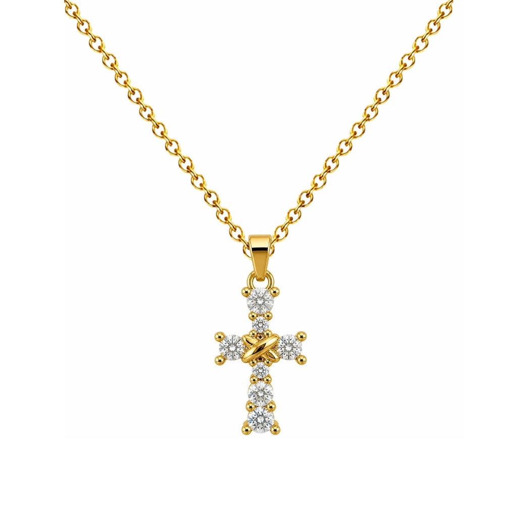 Collar de cruz dorada con circonitas, detalle del colgante sobre fondo blanco.