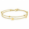 Pulsera doble dorada de acero inoxidable con motivos de estrellas.