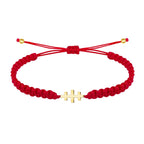 Pulsera de hilo rojo trenzado con Cruz de las Catacumbas horizontal en acero dorado y nudo ajustable.
