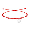 Pulsera de hilo rojo 7 nudos con charm minimalista de silueta calada de la Virgen de la Fuensanta en acero plateado
