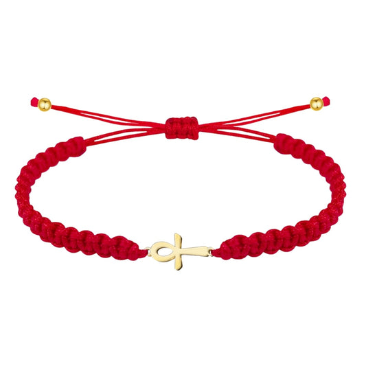Pulsera de hilo rojo trenzado con un diseño central de la Cruz Egipcia (Ankh) fabricada en acero inoxidable con acabado dorado, decorada con esferas metálicas doradas y cierre ajustable de nudo corredizo.