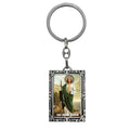 Llavero metálico rectangular con marco ornamental e imagen a todo color de San Judas Tadeo, túnica blanca y manto verde.