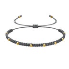 Pulsera de Hilo Encerado con Cuentas de Acero Inoxidable - Gris sobre fondo blanco