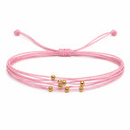 Pulsera Multihilo Encerado con Cuentas de Acero Inoxidable - Rosa sobre fondo blanco