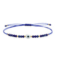 Pulsera de Hilo con Cuentas y Ojo Turco - Azul Marino sobre fondo blanco