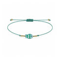 Pulsera de Hilo con Pez de Cristal y Ojo Turco sobre fondo blanco