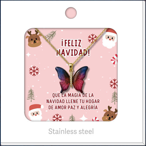 Collar de mariposa en tonos rosas y azules, presentado en tarjeta navideña.