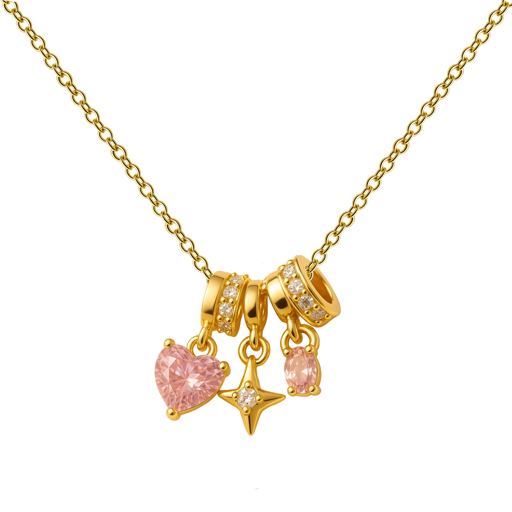 Colar dourado de coração cor-de-rosa e estrela, com três adornos suspensos, sobre fundo branco.