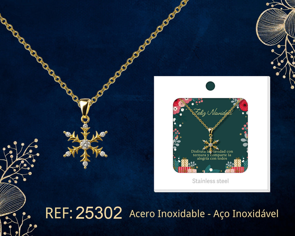 Collar dorado de copo de nieve junto a su tarjeta de regalo, sobre fondo oscuro.