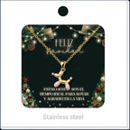 Balloon dog necklace in pink and gold tones, presented on a Christmas message card.