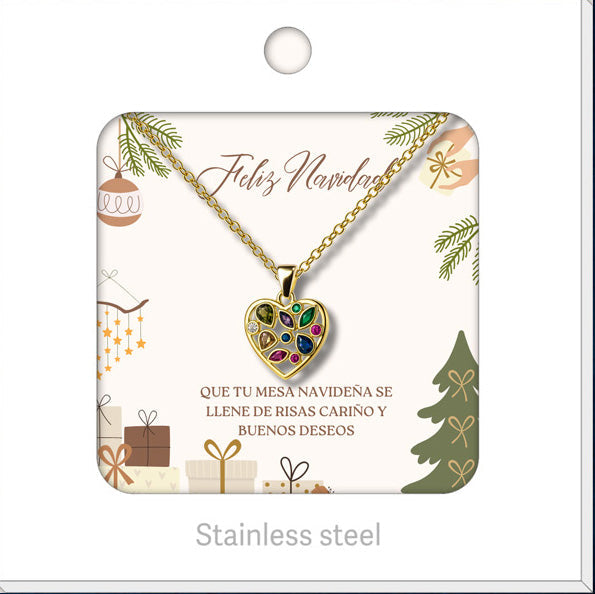 Collar dorado de corazón multicolor, presentado en tarjeta navideña.