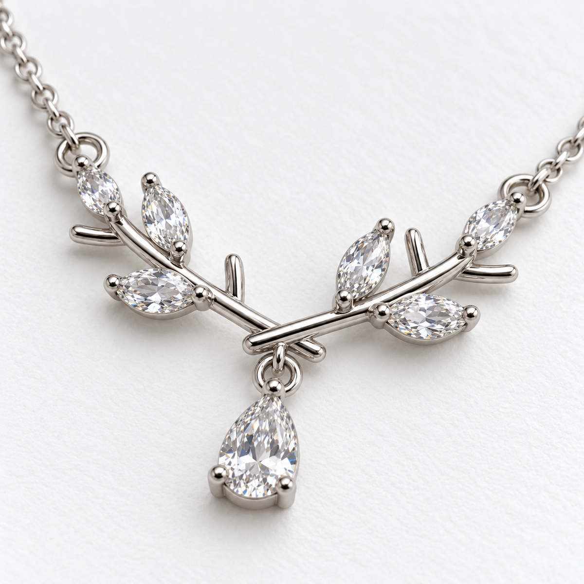 Silver Tone Branch Necklace with Teardrop Detail, viewed at an angle on a white background.