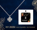 Silver Tone Four-Petal Flower Necklace beside its gift message card, on a dark background.