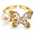 Anillo dorado de mariposa y esfera blanca