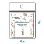 Charm dorado de número 1 con circonitas de colores con aro de acero, en blíster