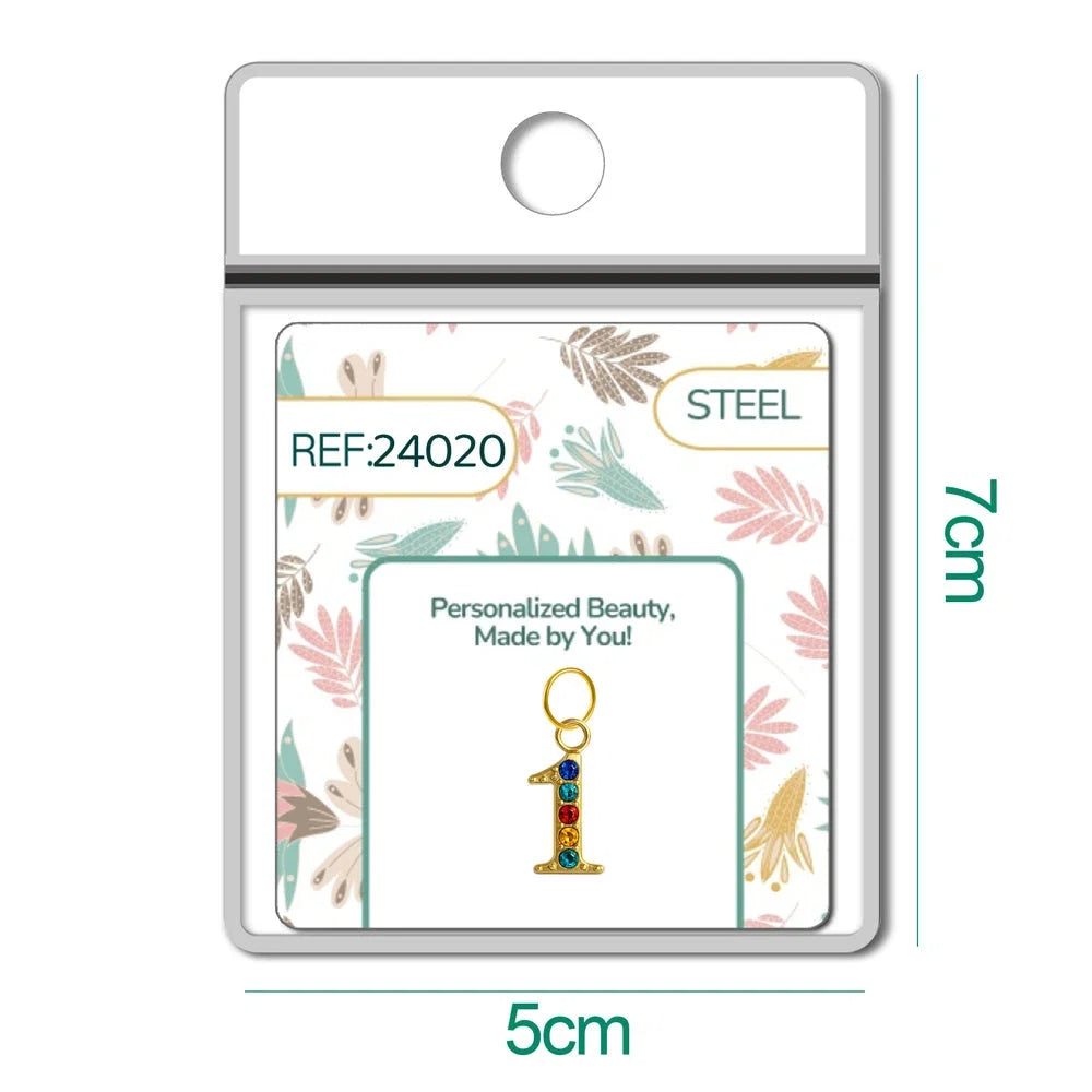 Charm dorado de número 1 con circonitas de colores con aro de acero, en blíster