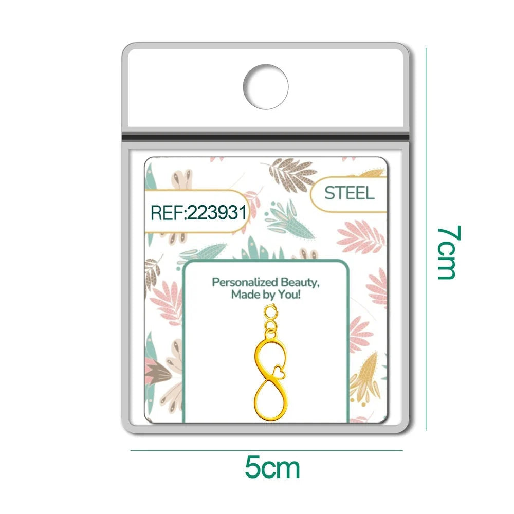 Charm dorado de infinito con corazón con cierre de acero en blíster