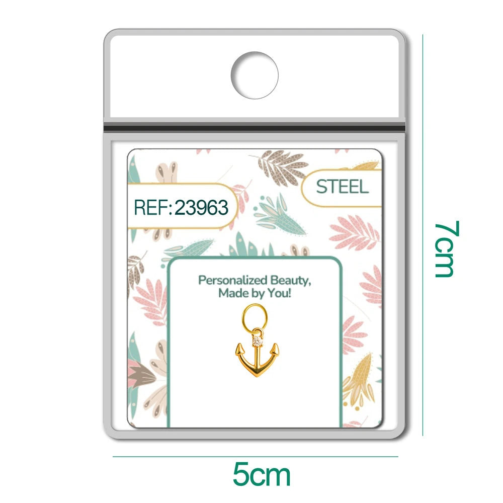 Charm de ancla dorado con circonita en blíster, vista frontal