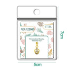 Charm dorado de círculo con estrella y circonitas con bola de acero con goma, detalle
