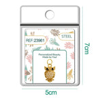 Charm de búho dorado con circonita en blíster, vista frontal