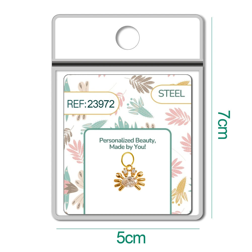 Charm de cangrejo dorado con circonita ovalada en blíster, vista frontal