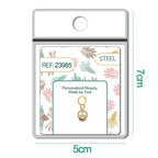 Charm dorado de círculo con estrella y circonitas con aro de acero, detalle