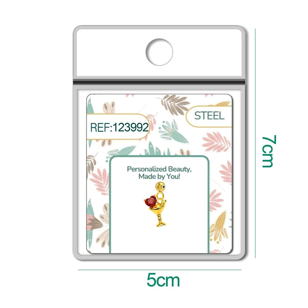 Charm dorado de copa de cóctel con corazón rojo con bola de acero con goma, en blíster