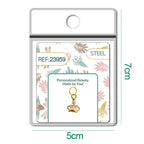 Charm de corona dorado con circonitas alargadas en blíster, vista frontal