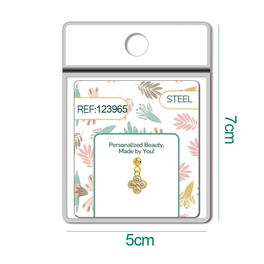 Charm de flor de cuatro pétalos dorado con circonitas y bola de acero con goma en blíster