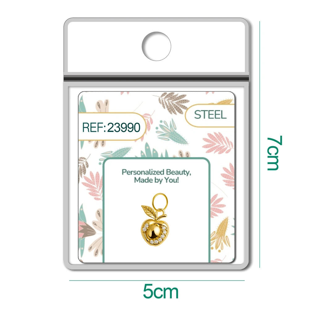 Charm dorado de manzana con circonitas con aro de acero, en blíster