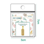Charm rectangular dorado pavé con circonitas y bola de acero con goma, detalle