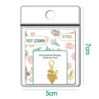 Charm dorado de racimo de uvas con circonitas lila con aro de acero, en blíster