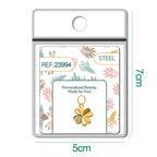 Charm dorado de trébol con tres circonitas con aro de acero, en blíster